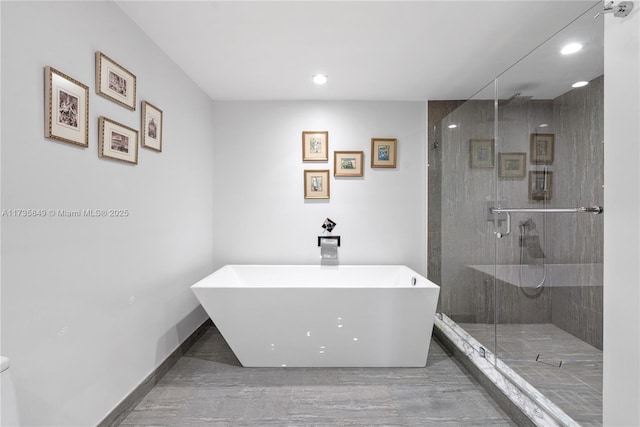 bathroom with shower with separate bathtub and sink