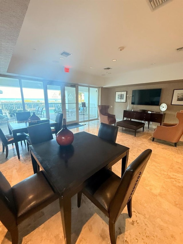 dining space featuring floor to ceiling windows