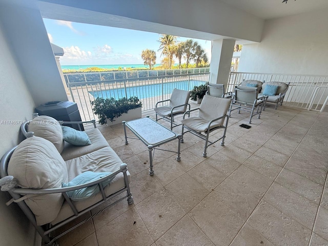 view of patio with a community pool and a water view