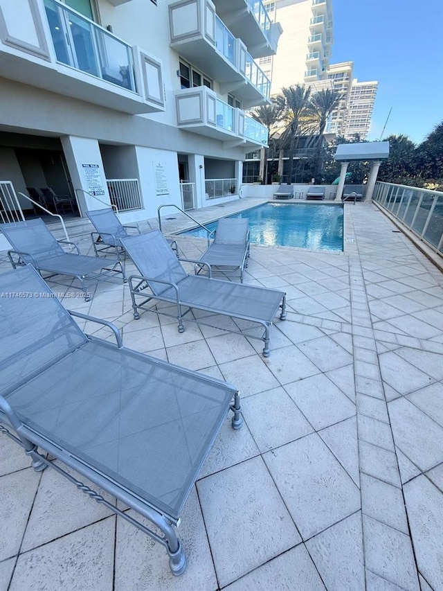 view of pool featuring a patio