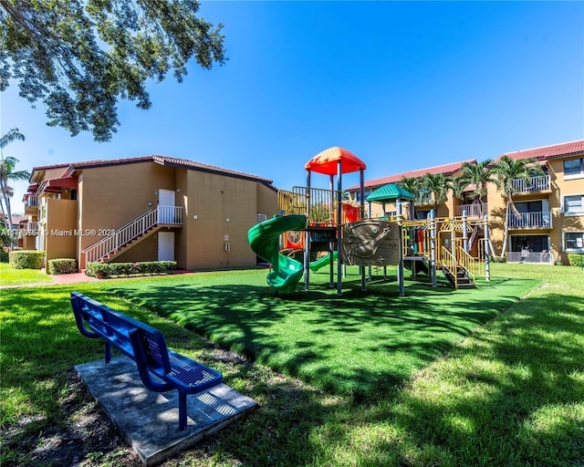 communal playground featuring a lawn