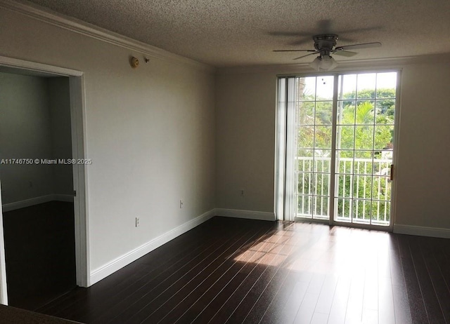 spare room featuring dark wood-type flooring, ceiling fan, ornamental molding, and a textured ceiling