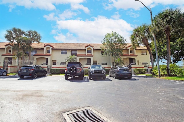 view of building exterior with uncovered parking