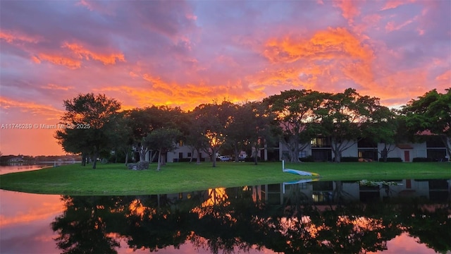 surrounding community featuring a water view and a yard