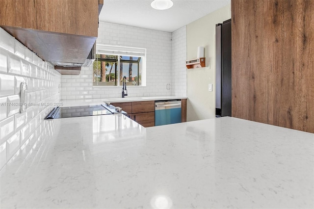 kitchen featuring a sink, light countertops, decorative backsplash, dishwasher, and brown cabinetry