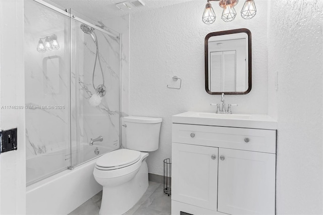 bathroom featuring a textured wall, toilet, shower / bath combination with glass door, vanity, and visible vents