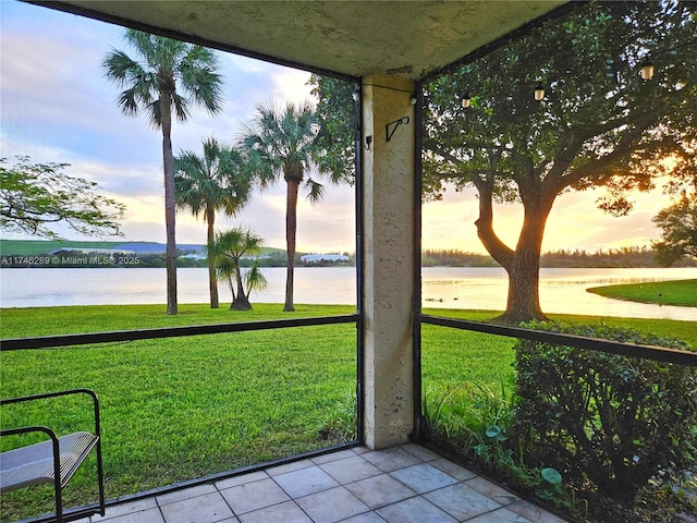 unfurnished sunroom with a water view