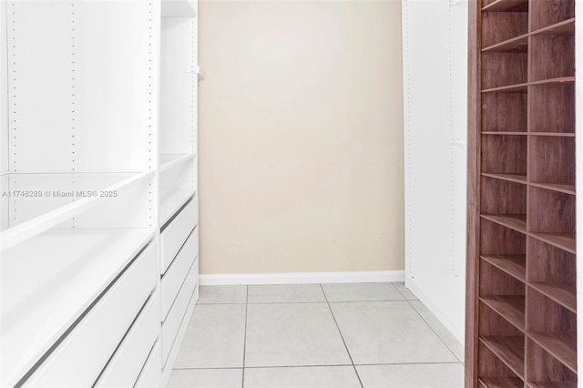 spacious closet with light tile patterned floors