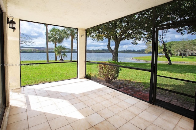 unfurnished sunroom with a water view