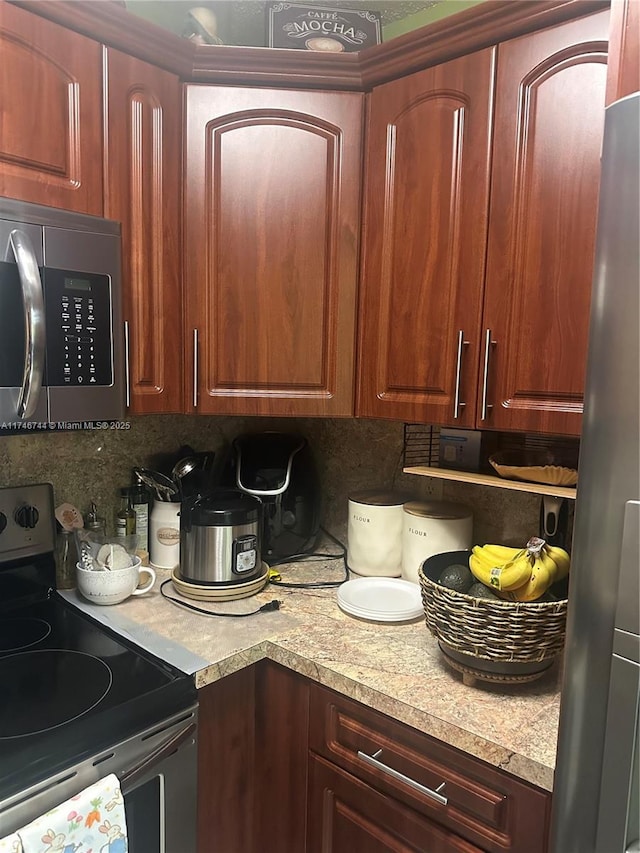 kitchen featuring stainless steel appliances and decorative backsplash