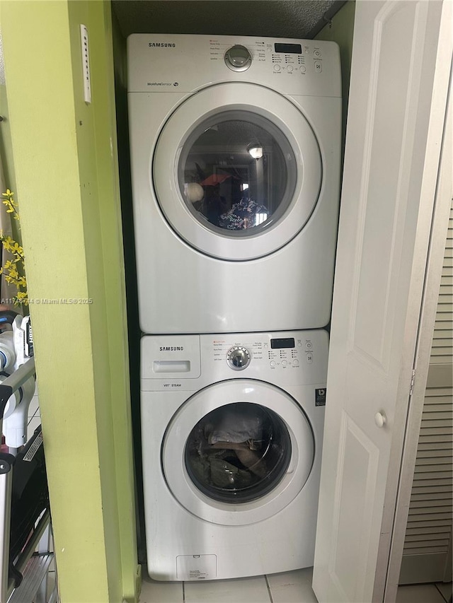 laundry room featuring stacked washer and clothes dryer