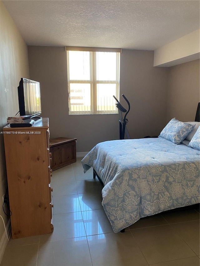 117 NW 42nd Ave Unit 507, Miami, FL 33126 - bedroom with a textured ceiling and light tile patterned floors