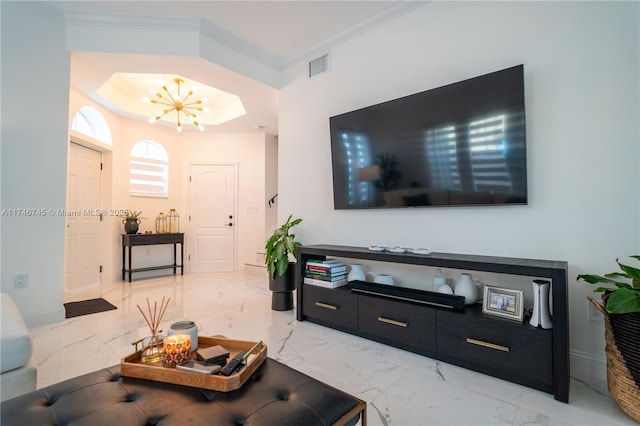 living room with ornamental molding and a chandelier