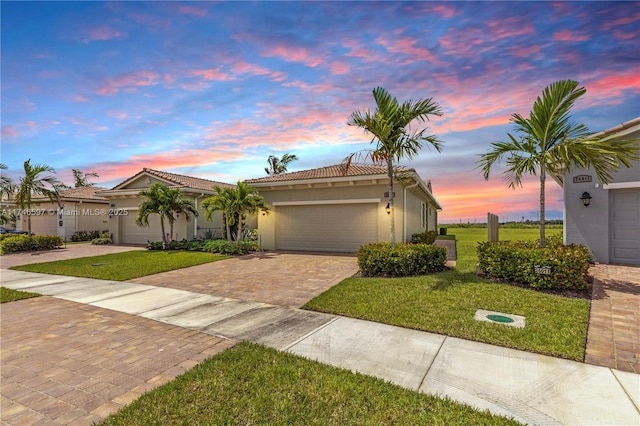 view of front of house featuring a garage and a yard