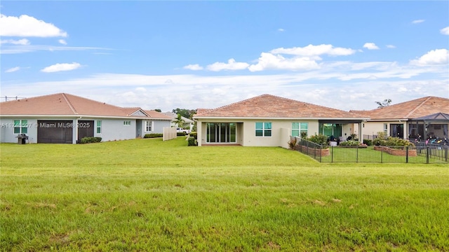 rear view of property with a lawn