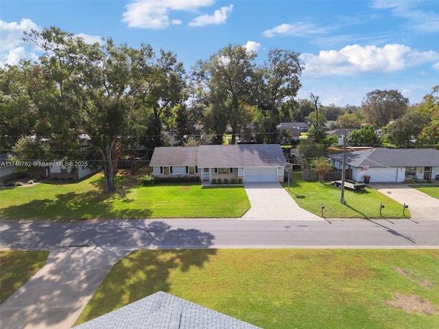 view of front of house with a garage and a front yard