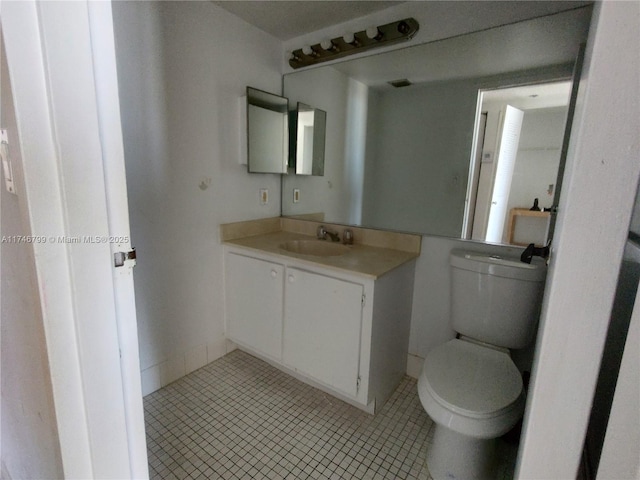 bathroom with vanity, tile patterned floors, and toilet