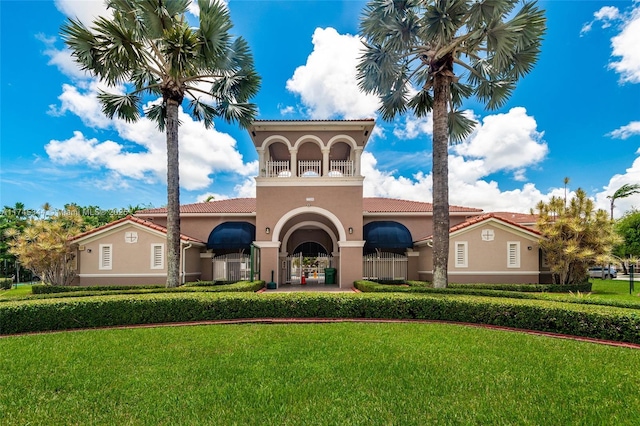 mediterranean / spanish-style house with a front yard