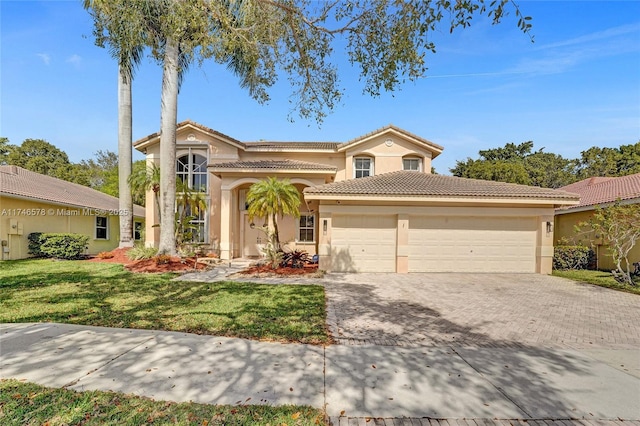 mediterranean / spanish-style house with a front yard and a garage