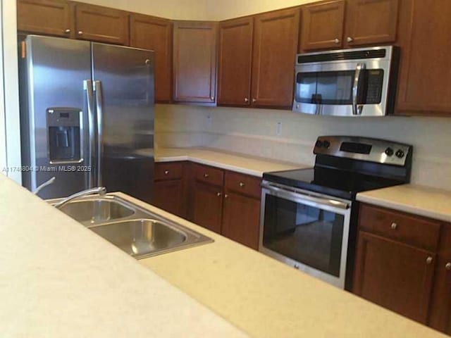 kitchen featuring appliances with stainless steel finishes and sink