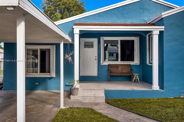 4711 NW 11th Ave, Miami, FL 33127 - view of exterior entry featuring a porch and stucco siding
