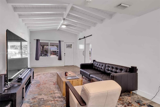 4711 NW 11th Ave, Miami, FL 33127 - living room featuring visible vents, baseboards, wood finished floors, a barn door, and vaulted ceiling with beams