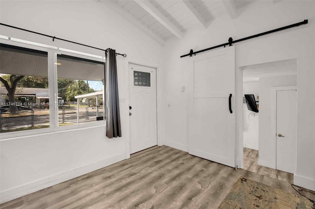4711 NW 11th Ave, Miami, FL 33127 - entrance foyer with a barn door, vaulted ceiling with beams, wood finished floors, and wood ceiling