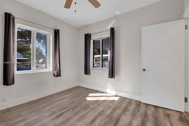 4711 NW 11th Ave, Miami, FL 33127 - spare room with wood finished floors, plenty of natural light, baseboards, and ceiling fan