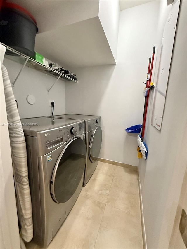 laundry room featuring laundry area, washer and clothes dryer, and baseboards