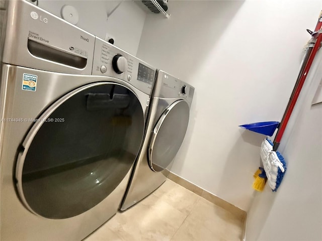 laundry area with light tile patterned floors, laundry area, and washer and dryer