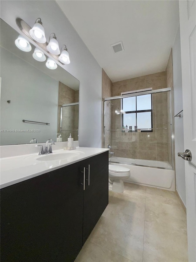 full bathroom with visible vents, toilet, enclosed tub / shower combo, vanity, and tile patterned floors