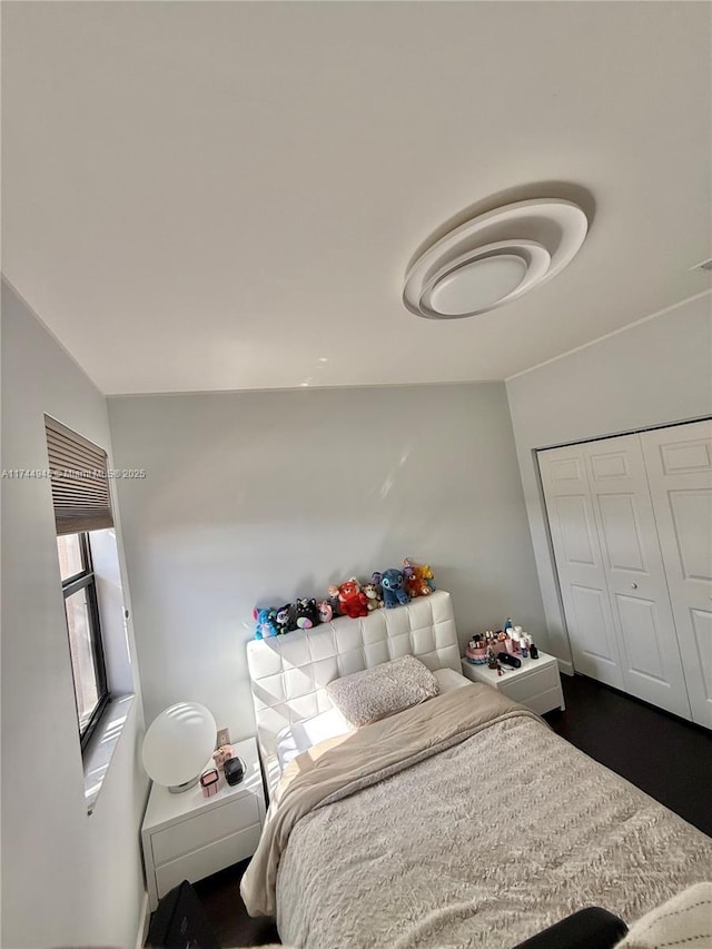 bedroom with a closet and wood finished floors
