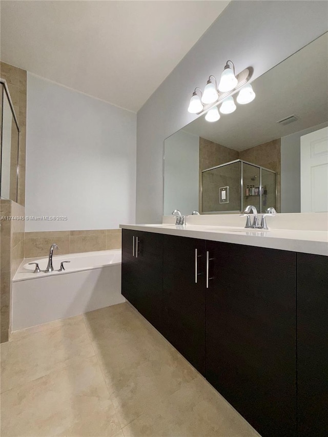 full bathroom with a garden tub, double vanity, visible vents, a stall shower, and tile patterned flooring
