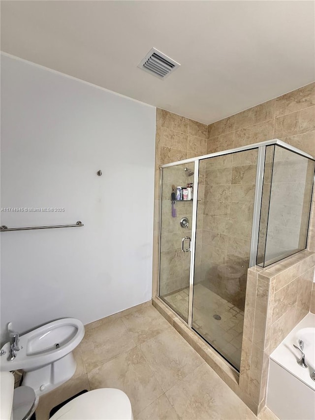 bathroom with toilet, visible vents, a stall shower, a bath, and a bidet