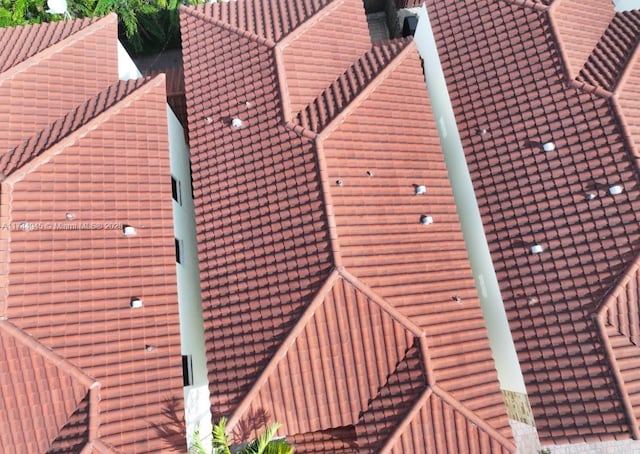 exterior space featuring a tiled roof