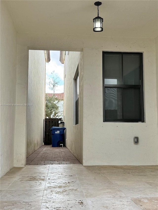 view of side of property featuring a patio and stucco siding