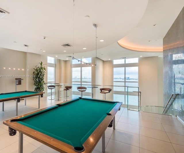 game room with floor to ceiling windows, a water view, visible vents, light tile patterned flooring, and billiards