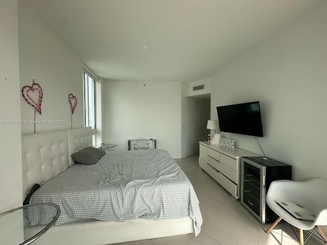 bedroom with light tile patterned flooring and visible vents