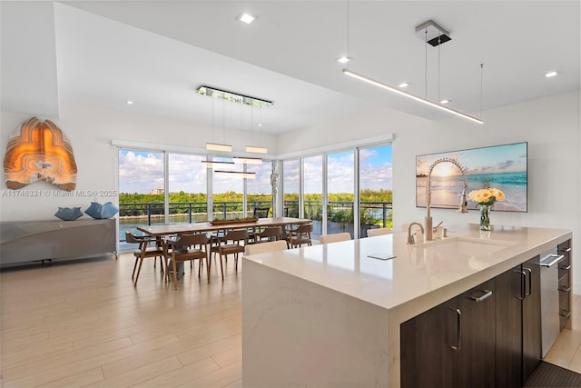 350 Desoto St, Hollywood, FL 33019 - kitchen featuring hanging light fixtures, a wealth of natural light, dark brown cabinets, and sink