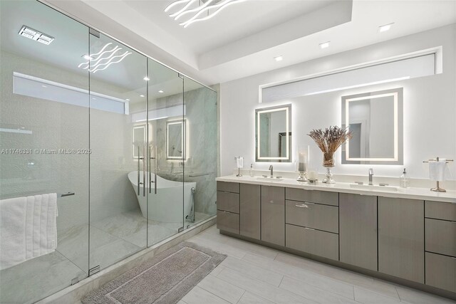 350 Desoto St, Hollywood, FL 33019 - bathroom featuring vanity, a tray ceiling, and a shower with door
