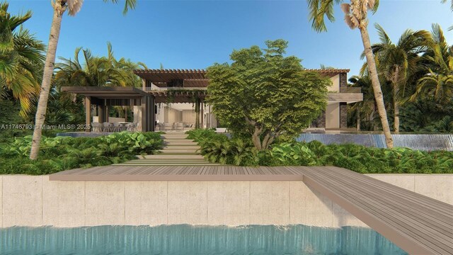 228302 W Dilido Dr, Miami Beach, FL 33139 - back of house featuring a pergola and stucco siding