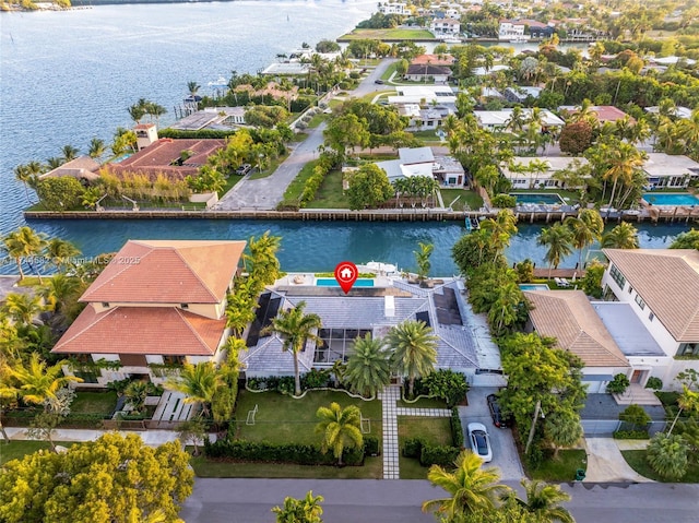 birds eye view of property featuring a water view and a residential view