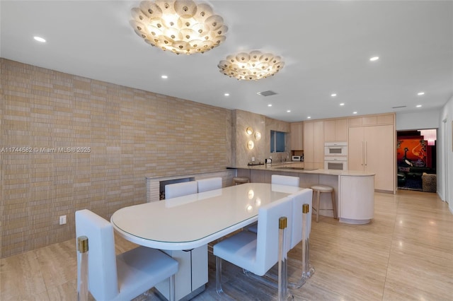 dining room featuring light tile patterned floors, tile walls, visible vents, and recessed lighting