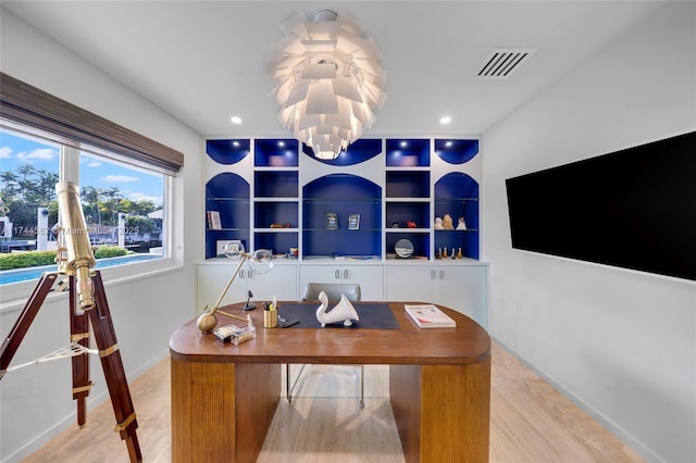 office featuring recessed lighting, visible vents, light wood-style flooring, and an inviting chandelier