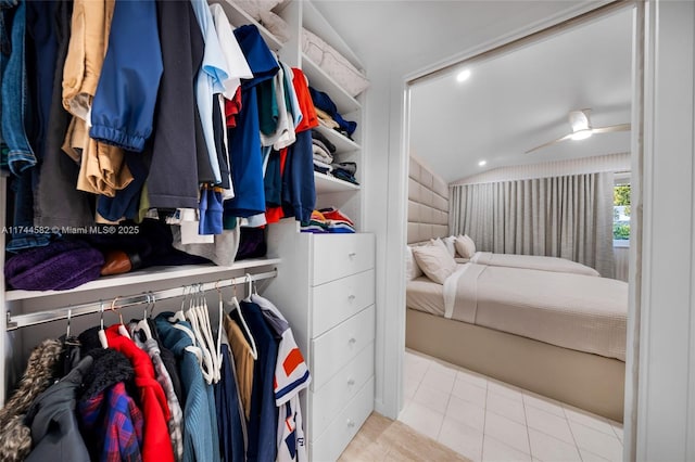 walk in closet featuring lofted ceiling and light tile patterned floors