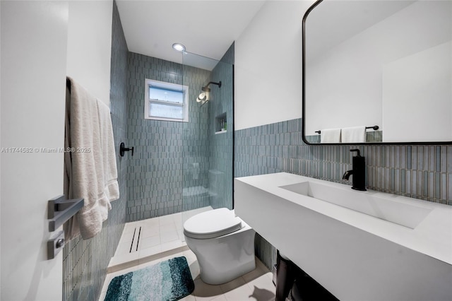 full bath featuring toilet, tile patterned flooring, vanity, a walk in shower, and tile walls