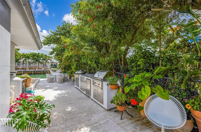 view of patio with a wooden deck and area for grilling