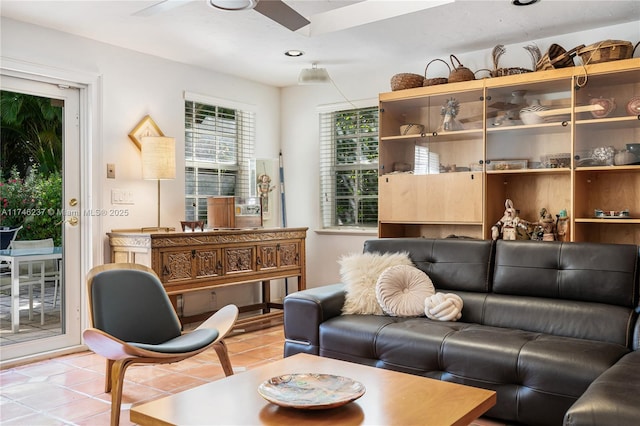 tiled living room with ceiling fan