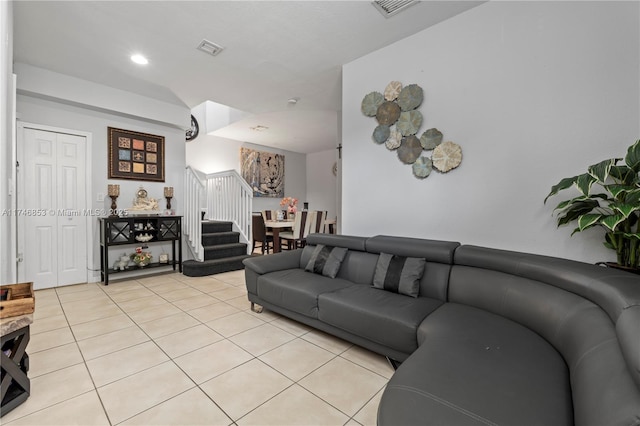 living room with visible vents, stairway, and light tile patterned flooring