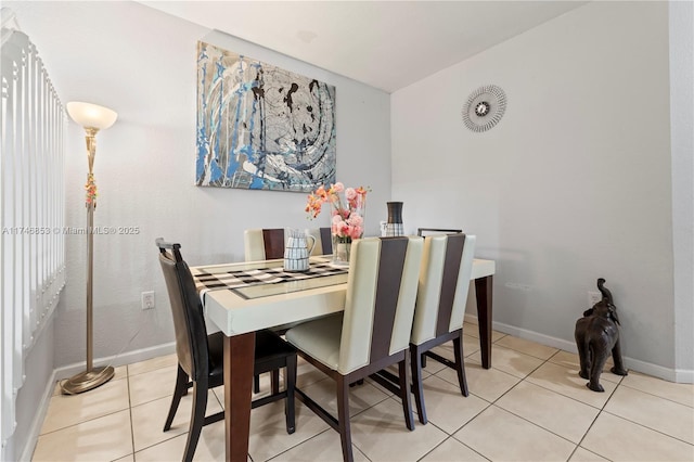 tiled dining room with baseboards